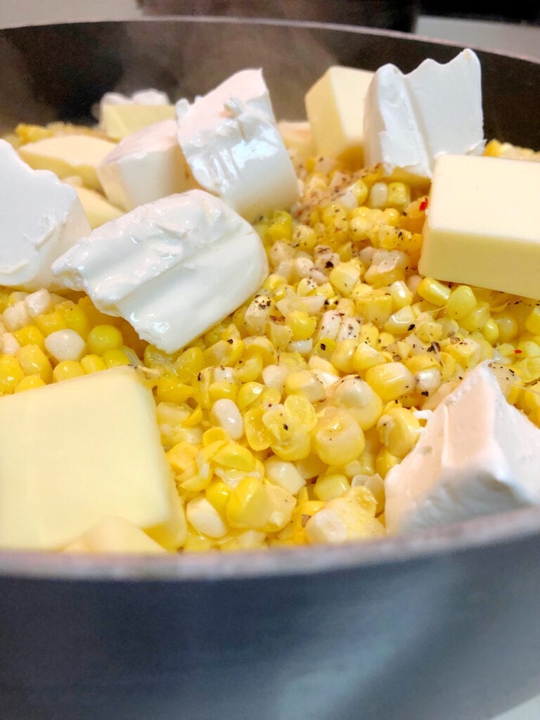 Adding Butter, Cream Cheese, Salt, and Pepper to the Corn