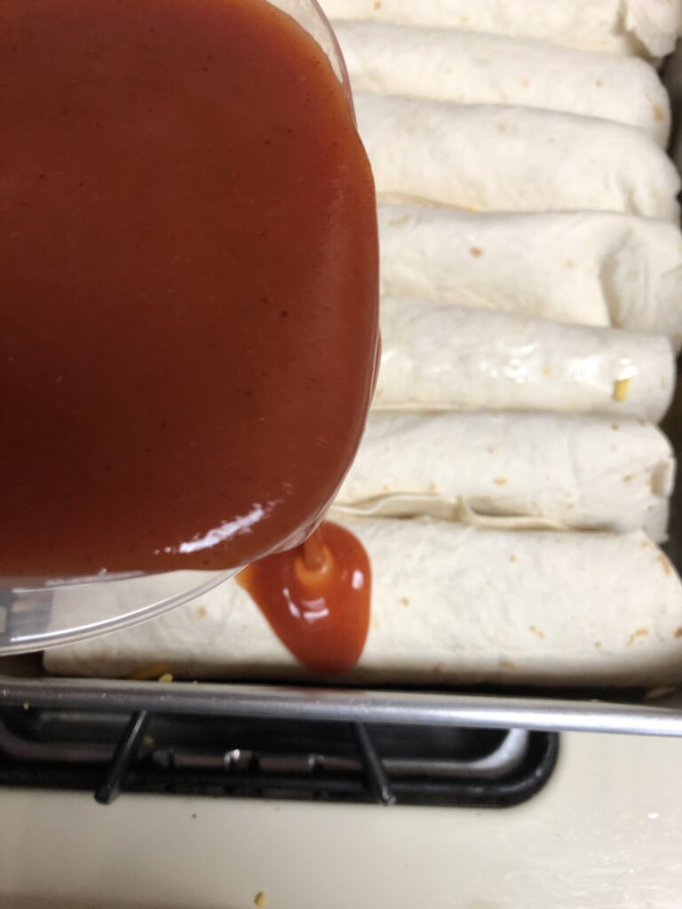 Pouring the Enchilada Sauce