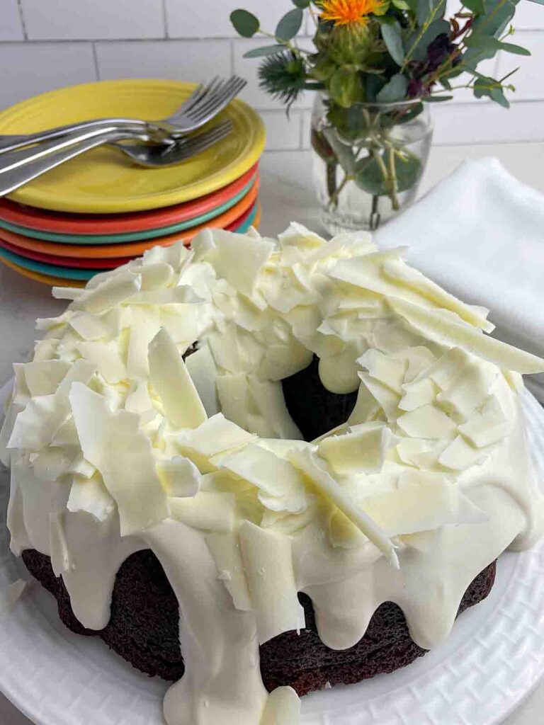 gingerbread-bundt-cake with white chocolate frosting on it 