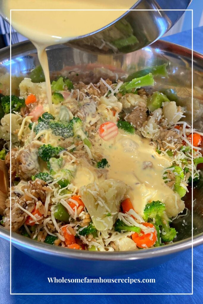 Pouring cheese sauce over rice and veggies
