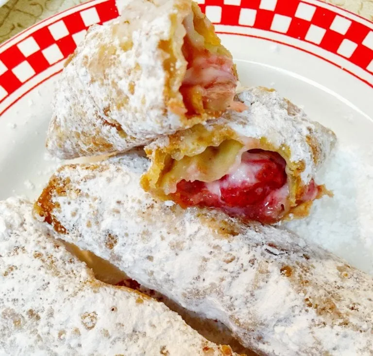 Homemade Strawberry Cheesecake egg rolls on a plate