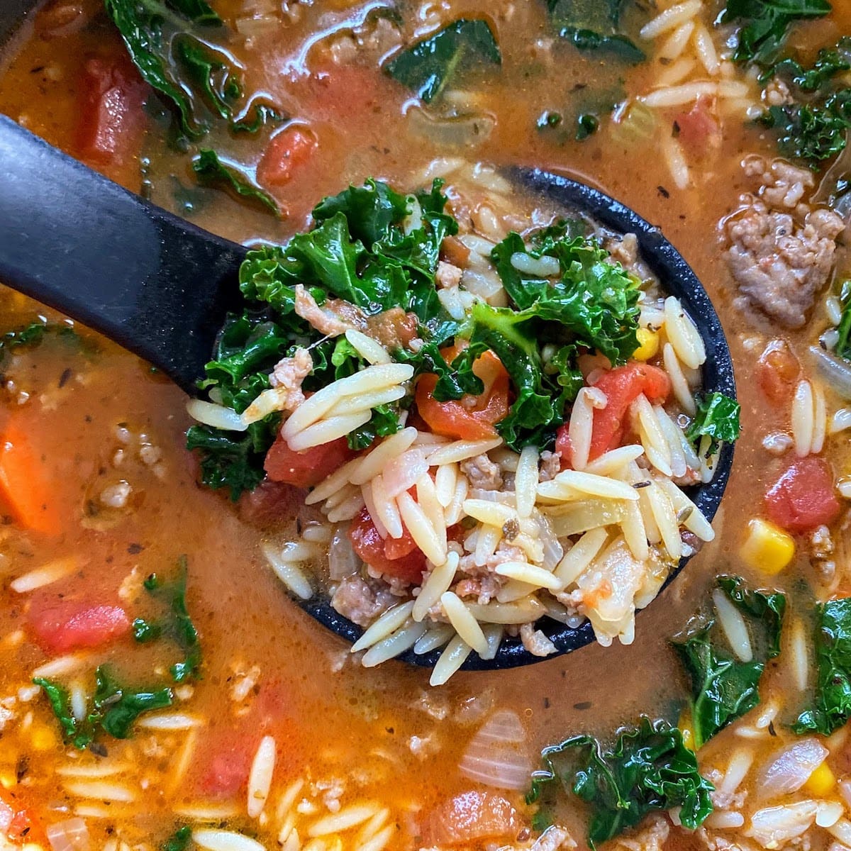 ladel of ITALIAN SAUSAGE SOUP WITH ORZO